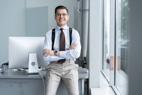 Portrait of a confident young businessman standing alone in a large modern office near his workplace. - Foto, afbeelding