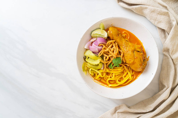 Northern Thai noodle curry soup with chicken (Kao Soi Kai) - Thai food style - Fotó, kép