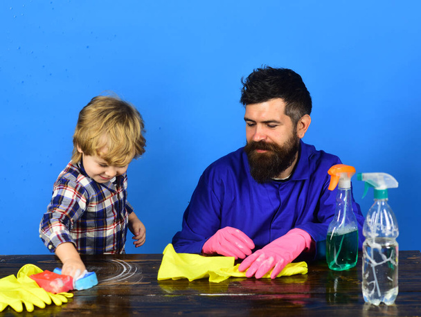 Guy with beard and mustache in gloves near cleaning props - Foto, Imagem