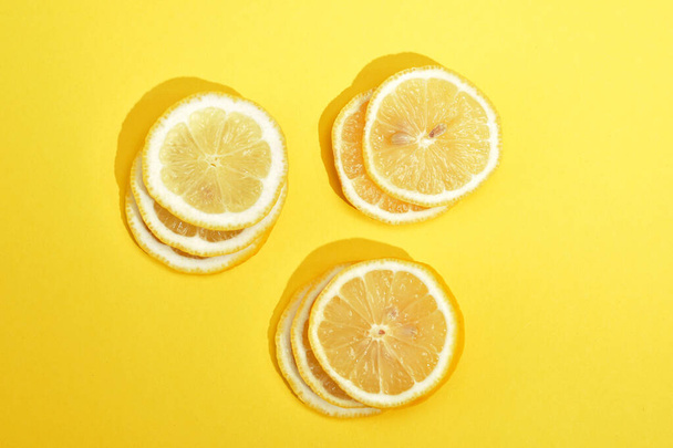 a lemon is cut for a background on a paper        - Foto, afbeelding