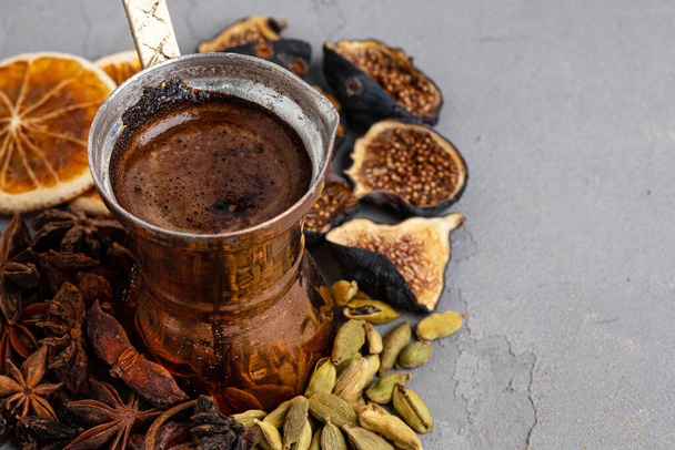Copper coffee turk with dried seeds and fruits on grey surface - Foto, Imagem