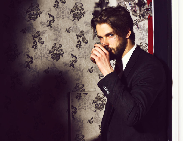 bearded man, businessman in suit, red tie holds whiskey glass - Zdjęcie, obraz