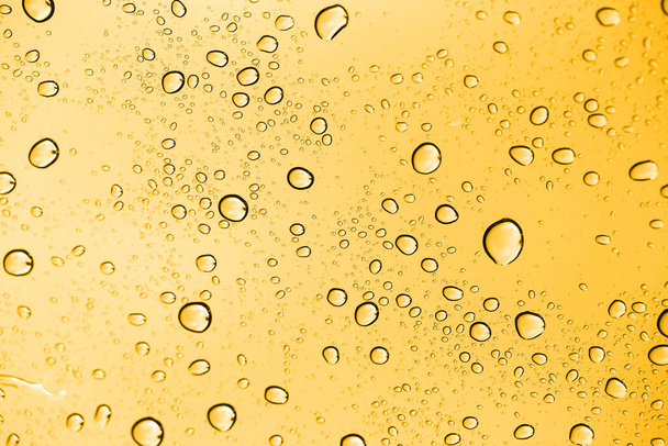 golden water drops on glass . Photo of an abstract texture - Photo, image