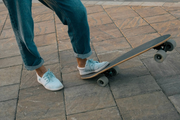 close up female legs with skateboard - Foto, afbeelding