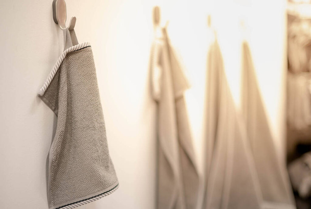 The grey towels hanging on the stand in supermarket. For the customer choose for use inside the house, Showcase the color with the decorate interior store. - Фото, изображение