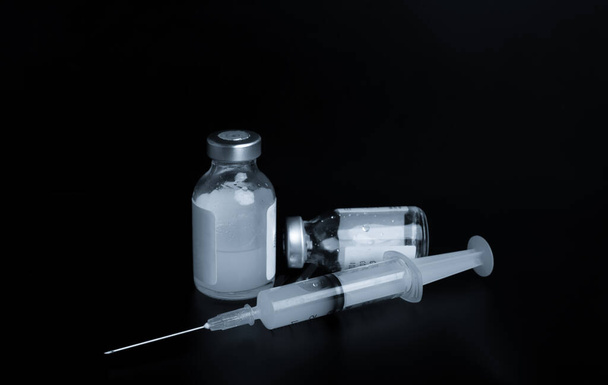 covid 19 vaccine on dark background, corona virus 2019 vaccine concept - Фото, изображение