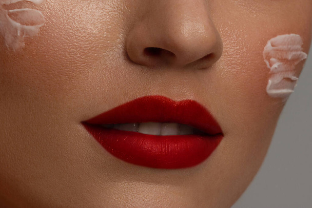 Perfect red lip maqullage. Close up macro cropped photo with beautiful attractive female mouth, wellness, wellbeing, treatment, therapy concept, isolated on grey background - Foto, Imagem