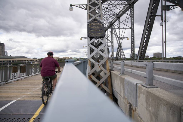 A biker biking on the Royal Alexandra Interprovincial Bridge  on the Ottawa river in Ottawa, Canada - Foto, Imagem
