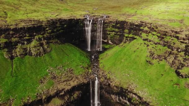 Aerial view of stunning waterfall in Faroe Islands. Aerial view of Fossa waterfall. Cloudy weather,establishing shot, no people. Majestic waterfall in wild rocky hillside. High quality footage. - Footage, Video