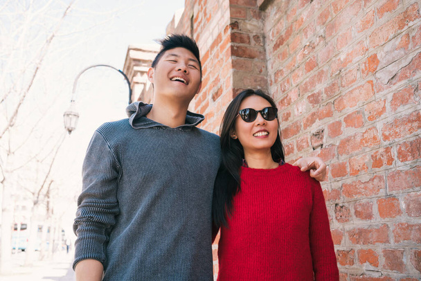 Portrait of young Asian couple in love walking in the city and having good time together. Love concept. - Fotó, kép