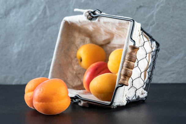 Fresh apricots in a white metallic basket - Fotoğraf, Görsel