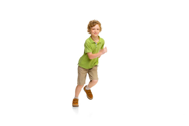 Happy little caucasian boy jumping and running isolated on white background - Foto, Bild