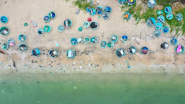 Many wooden Vietnamese traditional fisherman boats in the sea. Drone shot - Photo, Image