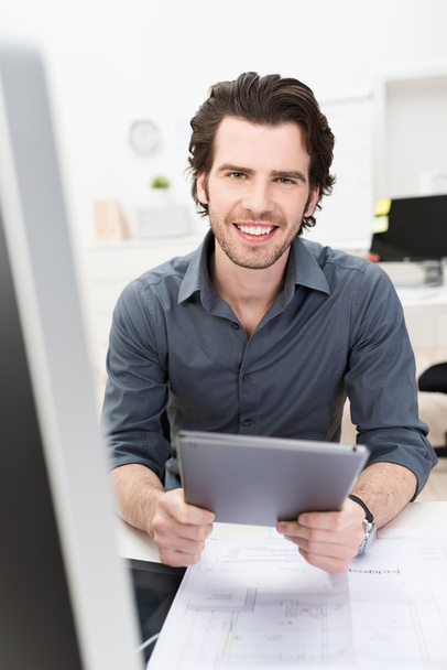 Friendly businessman holding a tablet computer - Photo, Image