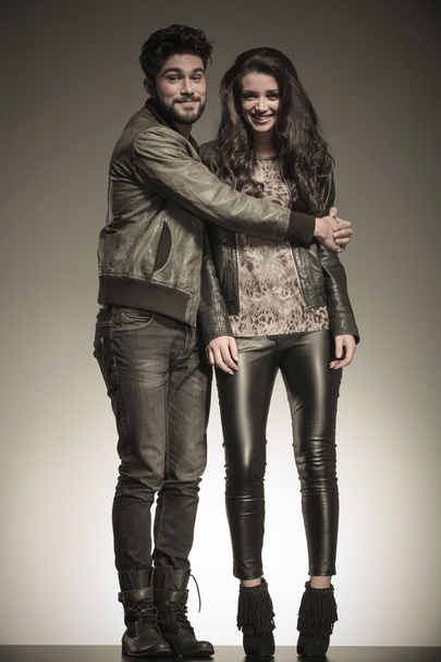 young man in leather jacket embracing his girlfriend - Photo, Image