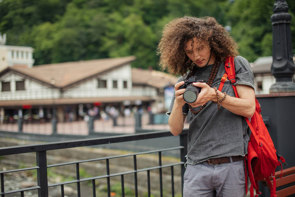 happy young man, tourists with camera in city. - 写真・画像