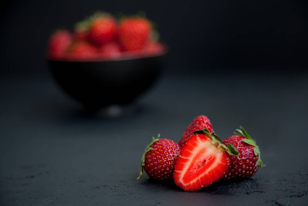 Ripe red fresh strawberries on a black background - Фото, зображення
