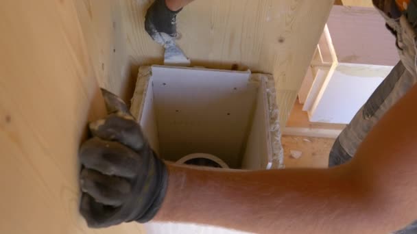 CLOSE UP: Unrecognizable builder smears paste around chimney shaft with spatula - Footage, Video