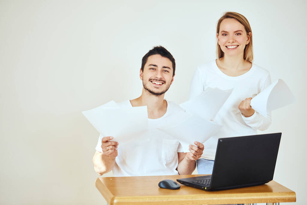 Happy couple at home paying bills with laptop - 写真・画像