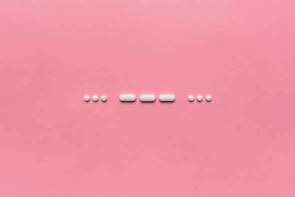SOS morse code with medical drugs and pills, top view flat lay conceptual image for addiction and overuse of medication - Photo, image