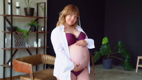 bodypositive. pregnant woman with overweight in underwear stroking belly. - 映像、動画