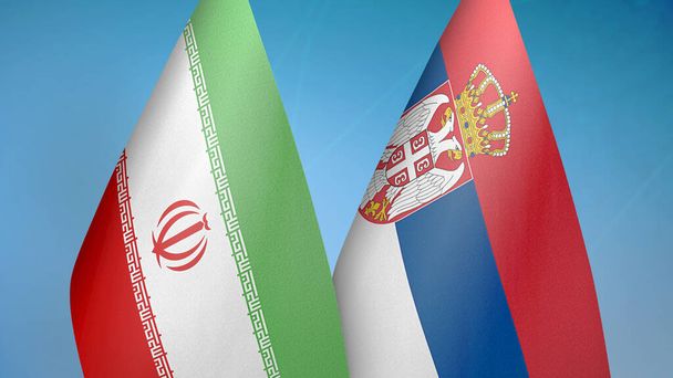Iran en Servië twee vlaggen samen blauwe achtergrond - Foto, afbeelding