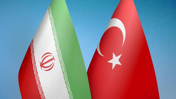 Irán és Törökország két zászló együtt kék háttér - Fotó, kép