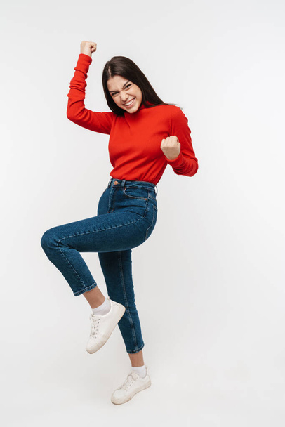 Photo of excited caucasian nice woman smiling and making winner gesture isolated over white wall - Photo, Image