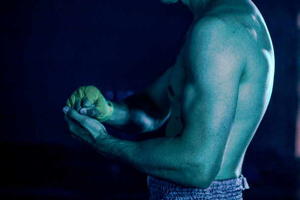 the man reels up on hands bandage for boxing - Fotó, kép