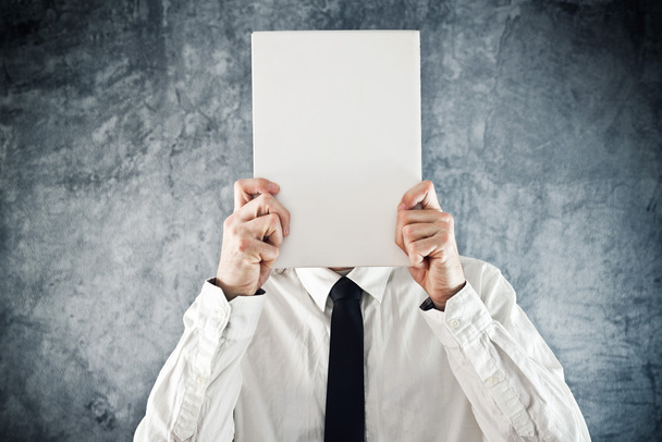 Businessman holding blank paper in front of his face - Foto, Bild