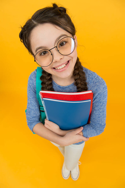 What would you like to read. Happy library reader yellow background. Little girl hold library books. Smart bookworm. School library. Knowledge and information. Bookstore. Its all about books - Φωτογραφία, εικόνα