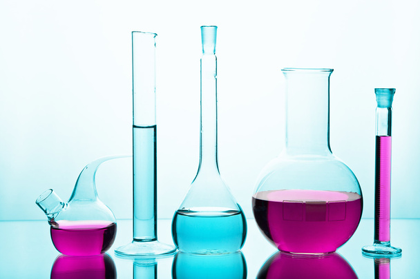 laboratory glassware with colorful chemicals - Foto, imagen