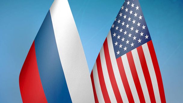 Rússia e Estados Unidos duas bandeiras juntos fundo azul
 - Foto, Imagem