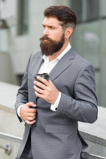 Brand energy. Confident male executive director with coffee to go. Successful man owner of business has coffee break. handsome guy wear expensive office jacket. morning cheerfulness with coffee - Fotoğraf, Görsel