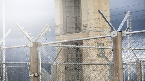 Fechar cercas da prisão e arame farpado e conceito de justiça criminal da torre da prisão
 - Foto, Imagem