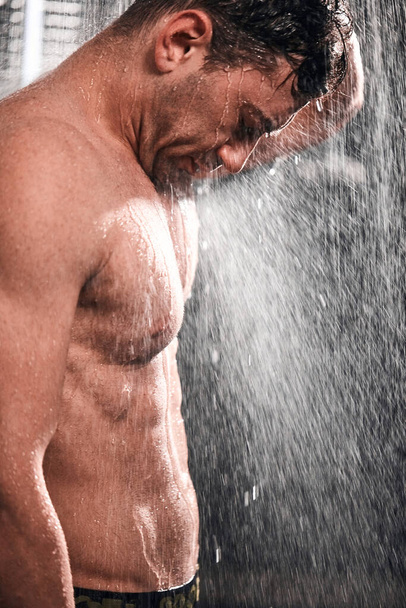 Handsome man taking shower, refreshing himself after a hot working day. - Zdjęcie, obraz