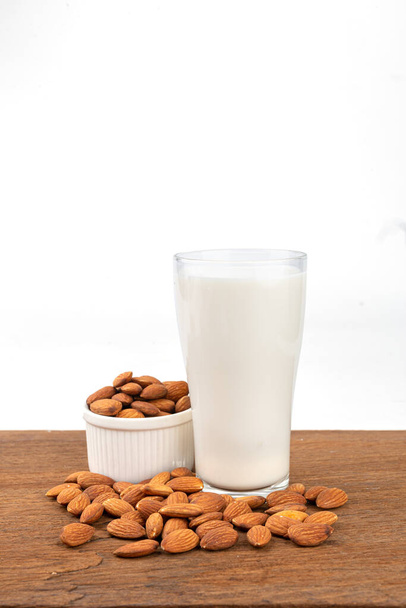 Close Up glass of Almond milk with Almond seeds.  on white background - Foto, afbeelding