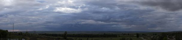 Landscape at sunset. Tragic gloomy sky. The village in the Budjak steppe. The terrain in southern Europe. Panorama. - Photo, Image