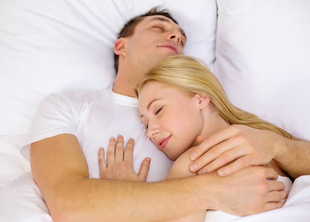 Happy couple sleeping in bed - Photo, image