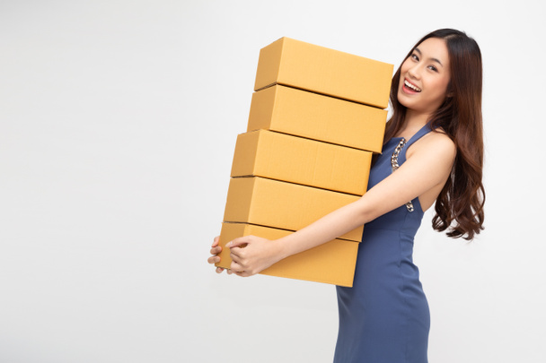Happy Asian woman holding package parcel box, Delivery courier and shipment service concept - Fotoğraf, Görsel