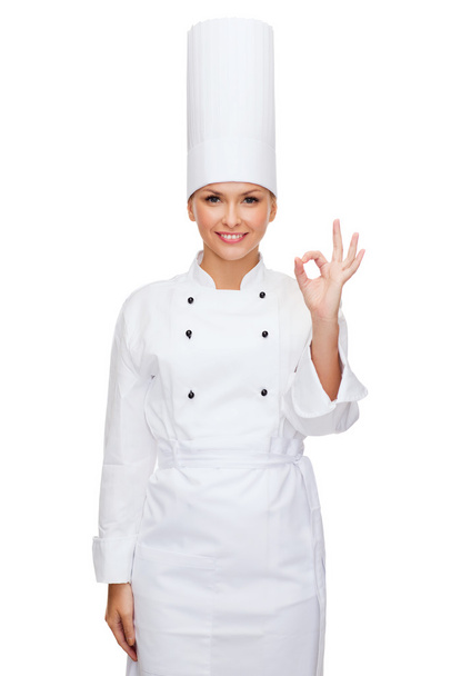 Smiling female chef showing ok hand sign - Foto, Imagem