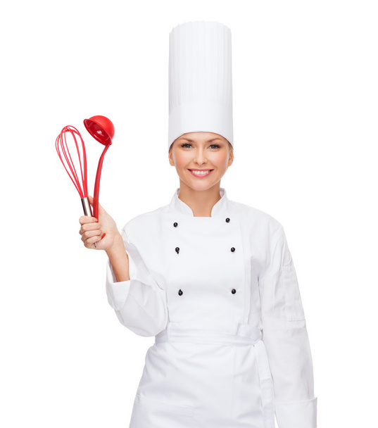 Smiling female chef with cooking equipment - Photo, image