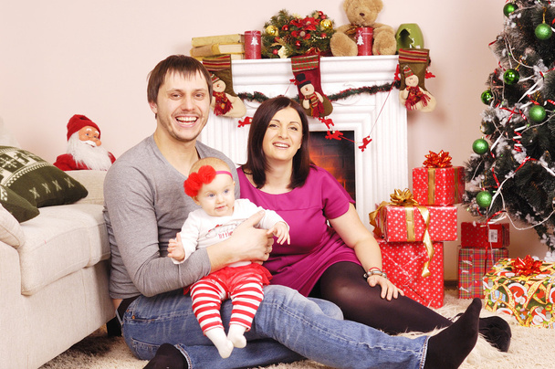 happy Christmas family near the fireplace - Fotografie, Obrázek