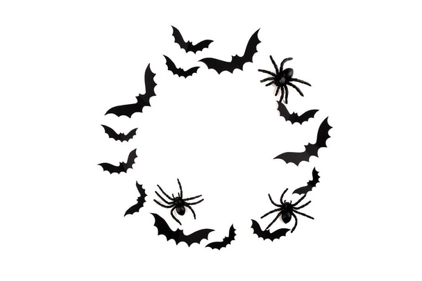 Halloween maqueta concepto. Murciélagos voladores de papel negro y arañas sobre fondo blanco. Marco redondo
 - Foto, Imagen