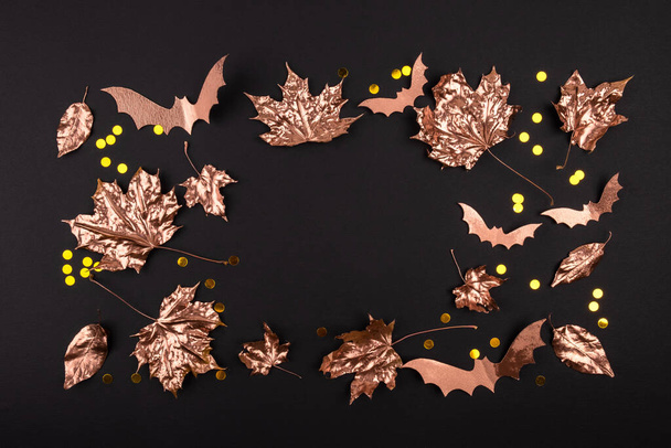Autumn composition. Golden maple leaves on black background. Autumn, fall concept. Flat lay, top view, copy space - Фото, зображення