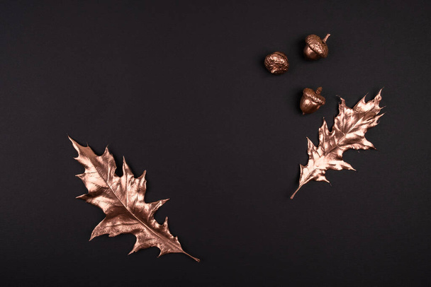 Autumn composition. Golden maple leaves on black background. Autumn, fall concept. Flat lay, top view, copy space - Photo, image