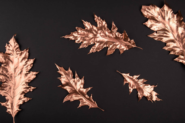 Autumn composition. Golden maple leaves on black background. Autumn, fall concept. Flat lay, top view, copy space - Photo, image