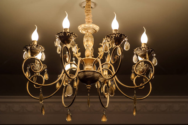 close up photo of chrystal chandelier lamp on the ceiling of a banquet hall - Photo, Image