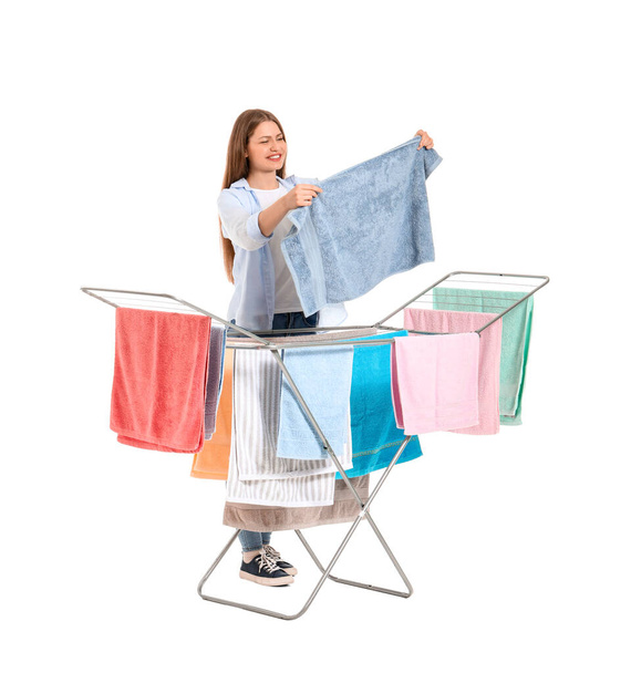 Woman with clean towels and clothes dryer on white background - Foto, imagen