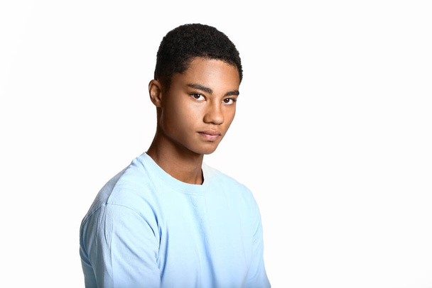 Sad African-American teenage boy on light background. Stop racism - Photo, Image